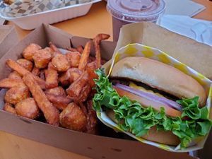 Box with sweet potato fries and tots, Beyond Burger, and a chocolate shake at Honeybee Burger - Venice in Venice