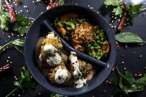 Potato croquettes, onion puree, mixed vegetables, pumpkin tofunaise with orange juice at Jídlo Baví in Prague