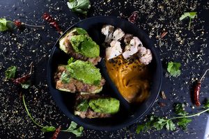 Stuffed zucchini with rice and pea pesto, sweet potato puree, marinated cauliflower at Jídlo Baví in Prague