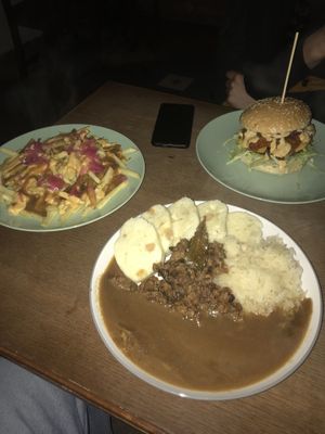 burger, fries and a traditional dish  at Shromaždiště in Prague