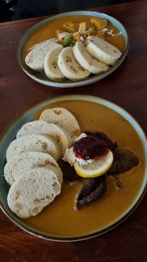 Czech dumplings with cream and cranberries at Shromaždiště in Prague