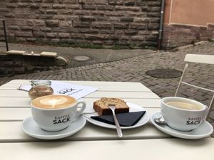 Oatmilk Cappuccino, bananabread and Americano  at Kaffeesack in Baden Baden