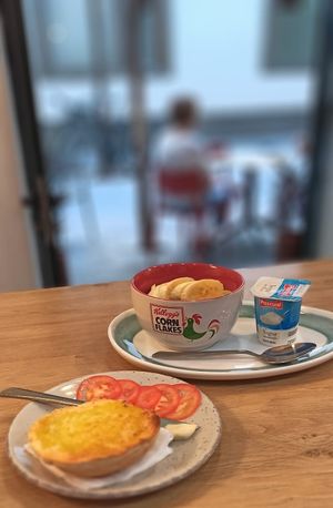 Tomate toast and Bowl Fruits, cereal and yogurt at Mango con Sal in Sevilla