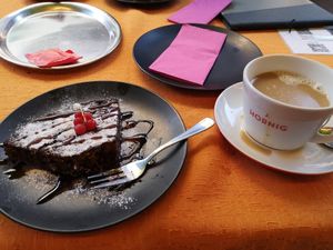 Yummy vegan banana bread with nuts served lukewarm. I also ordered a cappuccino with oat milk but it didn't really create a foam. at Amadeo in Bad Reichenhall