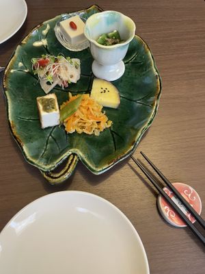 Appetizer, sweet potato, cucumber salad, lotus (raw, which was new to me), the white thing is made of sake rests (trester)  at Naramachi Vegan Nabi in Nara