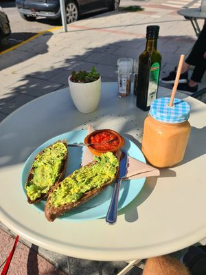 Avocado and tomato toast and delicious 100% fruit smoothie. at Café de Theresa in Estepona