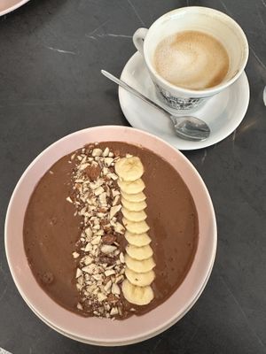 Chocolate smoothie bowl and coffee with almond milk   at Kavana Lattiera in Pula