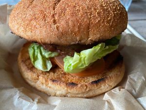 Beyond burger with little gem lettuce, tomato, pickles, mangoketchup and a chili bun. at The Green Room - Cityhotel Wood in Middelburg