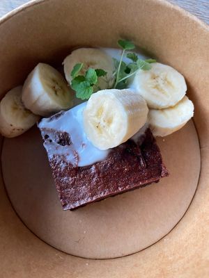 Chocolate brownie with homemade vegan yoghurt and banana. at The Green Room - Cityhotel Wood in Middelburg