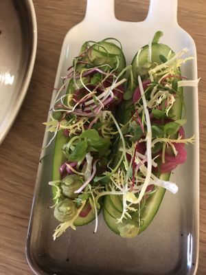 A side dish. Filled mini cucumber with avocado, pickled red union and sprouts.  at The Green Room - Cityhotel Wood in Middelburg