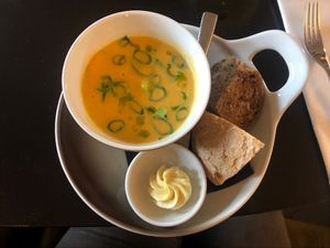 Sweet potato soup with coconutmilk, cashews, spring onion and avocado, served with bread and cuminbutter. at The Green Room - Cityhotel Wood in Middelburg