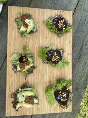 First round of the high tea: Flax seed crackers with red beet hummus and avocado with pesto. at Theetuin Het Kaslokaal in Oostkapelle
