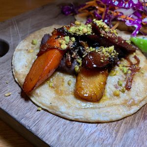 Heirloom Carrot Taco:  Aleppo Chili Flakes, Onions, Refried Black Beans, Pistachios.  From Vegan Taco Tuesday 1/16/24 at 600 Kitchen and Bar in Kalamazoo