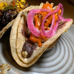Harissa Maple Cauliflower Taco: Refried Black Beans & Pickled Onions.  From Vegan Taco Tuesday 2/13/24 (every 2nd Tuesday of the month) at 600 Kitchen and Bar in Kalamazoo