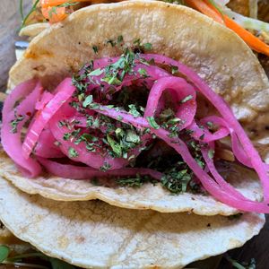 Soy-Orange Marinated Bok Choy Taco:  Grilled w/ Red Onion, Sesame Seed Sauce.  From Vegan Taco Tuesday 3/12/24 (every 2nd Tuesday of the month) at 600 Kitchen and Bar in Kalamazoo