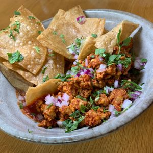 Tempeh Chorizo: Tomato Pepper Sauce, Onions, Cilantro, Tortilla Chips.  From Vegan Taco Tuesday 7/9/24 (every 2nd Tuesday of the month) at 600 Kitchen and Bar in Kalamazoo