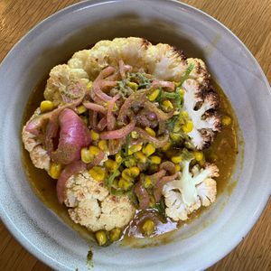 Cauliflower Steak: Yellow Curry, Scallion Salsa Verde, Grilled Corn Salad, Pickled Onions at 600 Kitchen and Bar in Kalamazoo