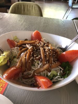 Salad with chikin strips on top and ginger dressing  at VeggiEAT - Summerlin in Las Vegas