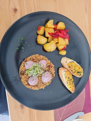 risotto w wild mushrooms, boiled potatoes w bell peppers, baguette w vegan egg - kala namak toasted goodness.  at Planet One in Arbon