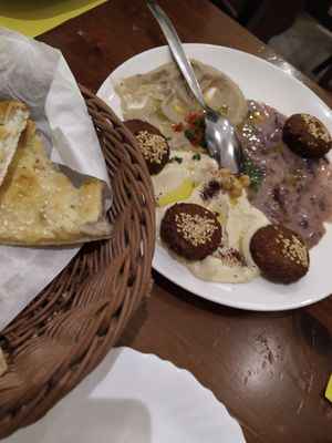 hummus, baba ghanoush, bean spread, falafel and sesame bread at Pizzeria Little Star in Cagliari