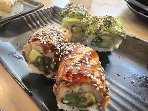 Foreground: vegan “eel” (eggplant) roll. Background: unknown delicious roll.  at Wellness Sushi in Denver