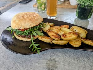 Vegan homemade bean burger with roast potatoes. Potatoes were good combined with the cream from the sweet potato rösti. at Altes Backhaus in Bleialf