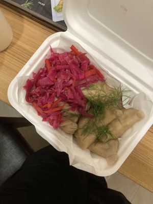 Potato varenyky with pickled cabbage for takeout. Mine did not have cashew cream as I am allergic.   at KURUMI in Da Nang