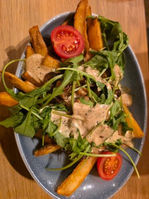 Loaded fries with mushrooms and truffle mayo at Hans Im Glück - Mercedes Platz in Berlin