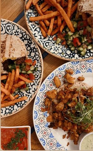 Pita’s with falafel and sweet potato fries. Optional salad mixture (this one is tomato&paprika salad)  at Mazel Tov in Budapest