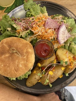 Le burger in seitan with potatoes and salad   at La Plume Végétale in Aix-en-provence