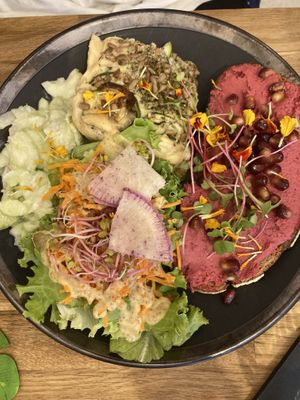 Brunch plate with a pate of zucchini, cucumber salad and pink hummus on toast.   at La Plume Végétale in Aix-en-provence