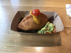 Beet empanada;  notice cardboard plate at Jajaja Mexicana - Hudson Yards in New York City
