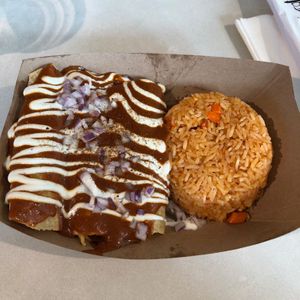 Enchiladas Mole with their own "pollo" (3) and a big helping of Spanish rice. at Jajaja Mexicana - Hudson Yards in New York City