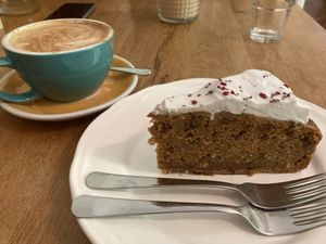 A piece of carrot cake and soy cappuccino   at Arome in Bucharest