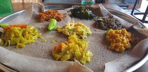 Bed of Teff ingera (gluten free extra easy to digest),  Lentils cooked in three different spices, spinach, and also Aliccia, don't recall the dish in the middle. Delicious  at Addis Kitchen in South East London