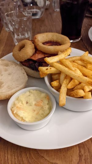 Onion ring burger with chips and coleslaw at The Dorset Burger Company in Weymouth