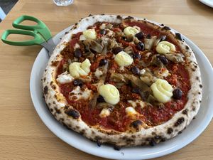 Pizza with cool pizza scissors   at Pizzeria Grano in Vancouver