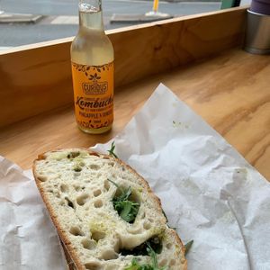 Kombucha and pesto and vegan ham sandwich  at How On Earth in Exeter