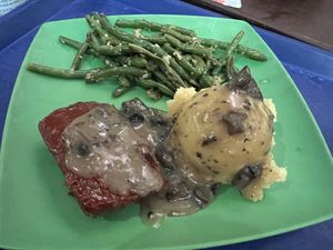 Plant-based Impossible meatloaf meal with a side of garlic green beans and mashed potatoes with mushroom gravyy  at Walt Disney World - Landscape of Flavors in Lake Buena Vista