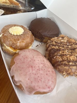 Peaches and cream, Boston cream, Samoa and almond chewy. All so good.   at Joyfully Baked in Gainesville
