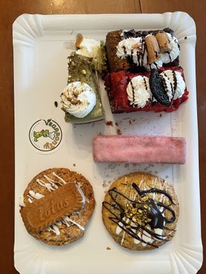 (From left to right, up-down) Pistachio cheesecake, Cookie dough brookie, Red velvet brookie, Panterita, Lotus cookie, and Pistachio white chocolate cookie  at Vegabonty in Fuengirola