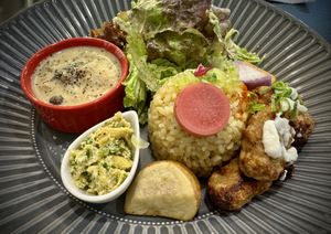 Meal Set featuring stew, Chinese yam wrapped in rice paper, house made “egg”, baked nuggets, salad, and more … 100% vegan and 100% delicious!  at Vegeto LIKO in Sendai