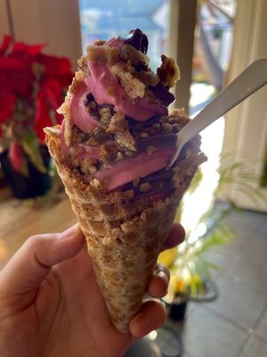 Regular waffle cone with Aloha strawberry and blueberry Ube swirl topped with waffle chips! Sooo good at Sweet Journey Soft Serve in Kailua Kona