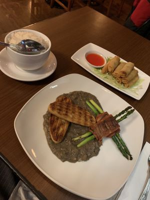 Spring rolls, chicken on bed of mushroom sauna, vg bacon wrapped wound asparagus   at The Orchid Vegan Restaurant in York