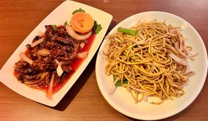 Crispy ‘beef’ in OK sauce and side of noodles   at The Orchid Vegan Restaurant in York