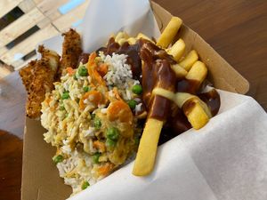Fries with Gravy Topped with Curry Rice and Some Mozzarella Sticks.  at KD's Vegan Takeaway in Townsville