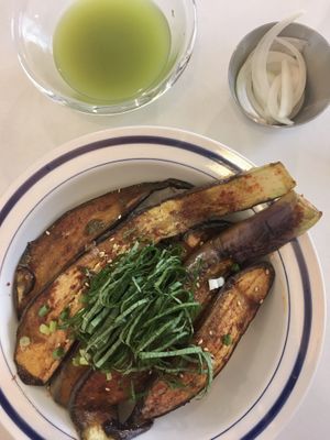 Eggplant rice comes with cold green tea and some lightly pickled onions  at LoveUrth 러브얼스 in Busan