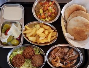 Our famous F & F consisting of Falafel, Chips , Foul(fava beans cooked with Egyptian style) and flavoursome Aubergine dipped in our Egyptian sauce. at Time Out Cafe in Glasgow