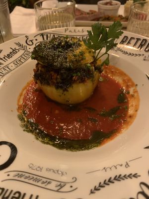 Stuffed pepper with mixed cereals and beans, on top of tomato sauce. Topped with pesto   at Au Vieux Gassin in Gassin