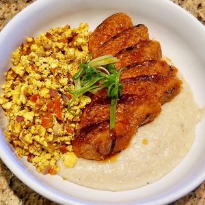Grits, Egg n' Sausage (GF) - creamy grits, tofu scramble, beyond sausage 
(Weekend Brunch Only) at Down 2 Earth Plant Based Cuisine in Las Vegas
